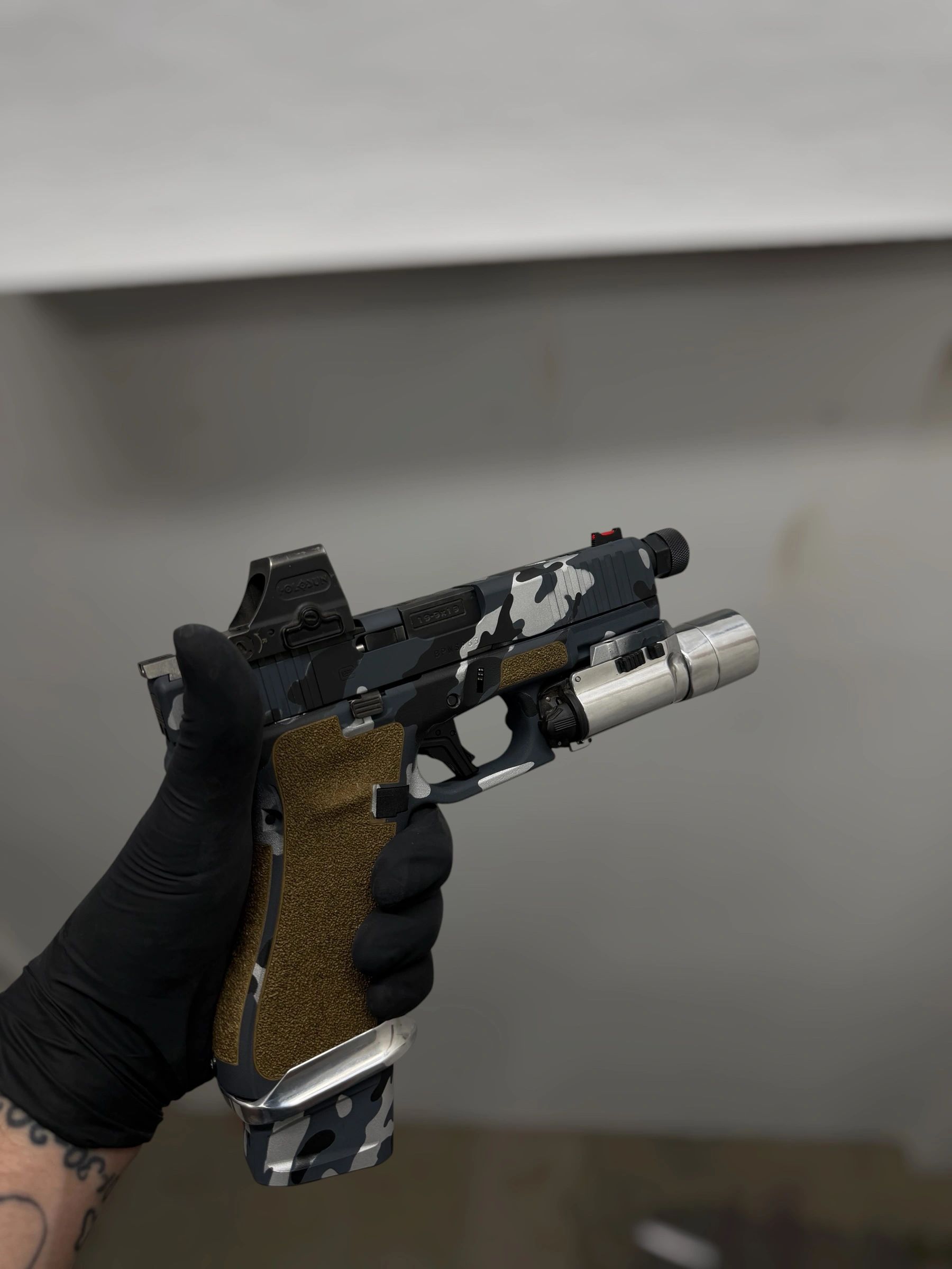 Finished custom pistol with a camouflage Cerakote finish
